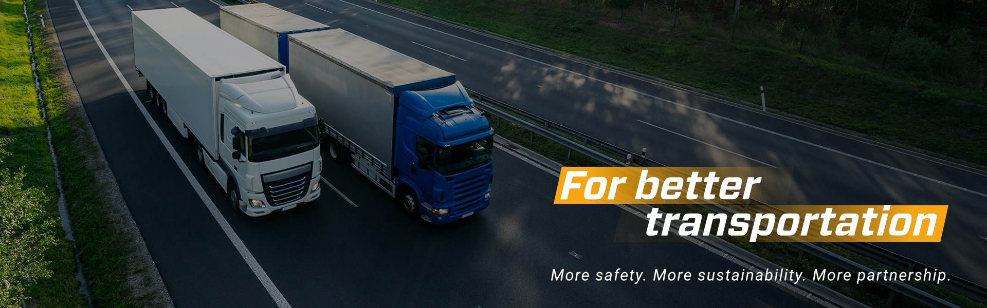 Two trucks on a highway with the slogan "For better transportation."